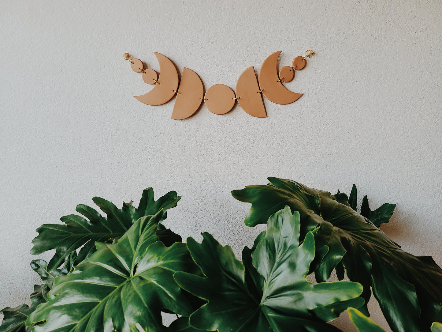 hanging horizontally with two wooden tacks provided in packaging, this lunar wall art design is sure to complement your house plants planted in terracotta ceramics.